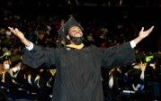 This enthusiastic student spots a familiar face in the crowd before crossing the stage. Photo Chuck Thomas/ODU